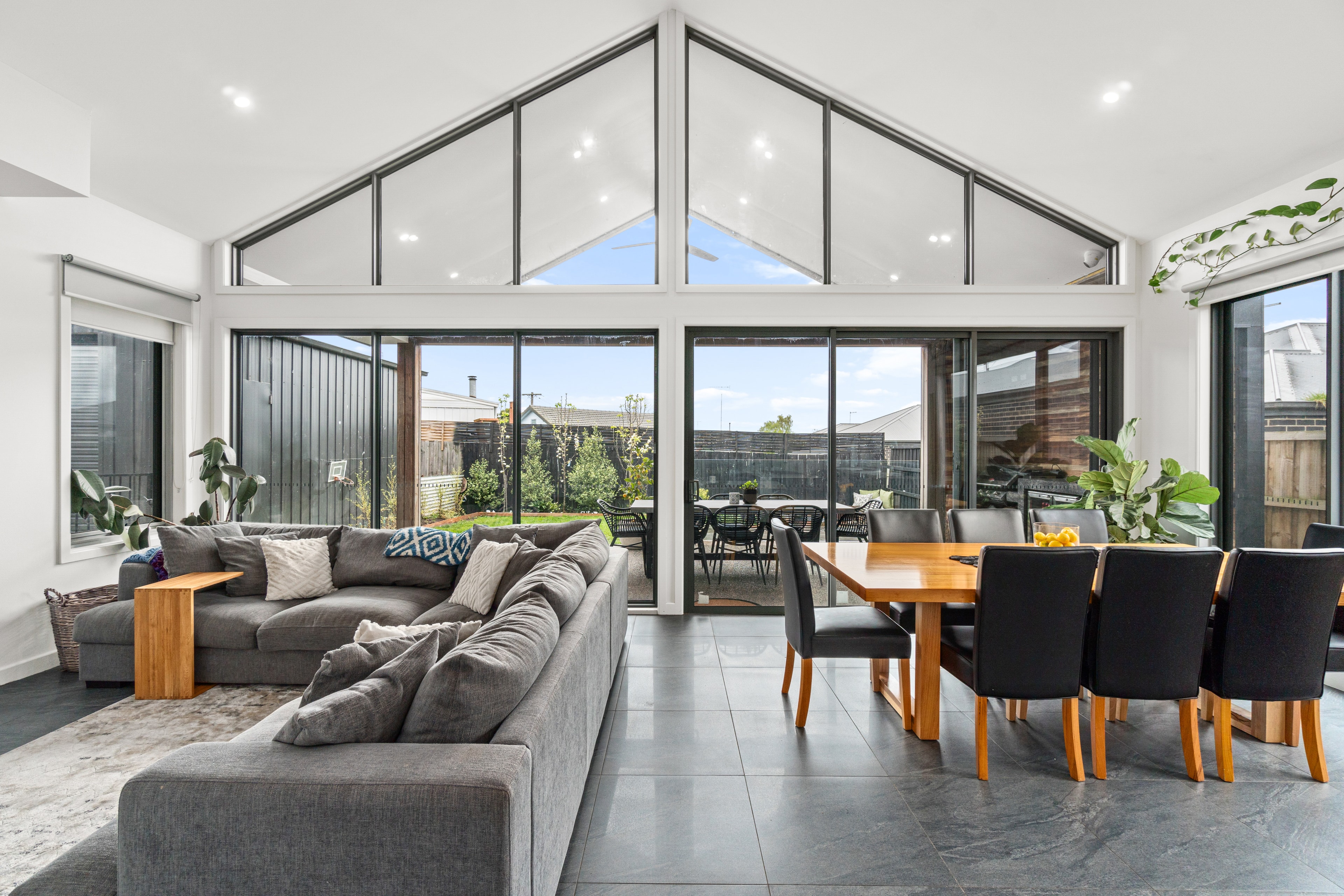 Cathedral ceiling living and dining room with floor-to-ceiling glass