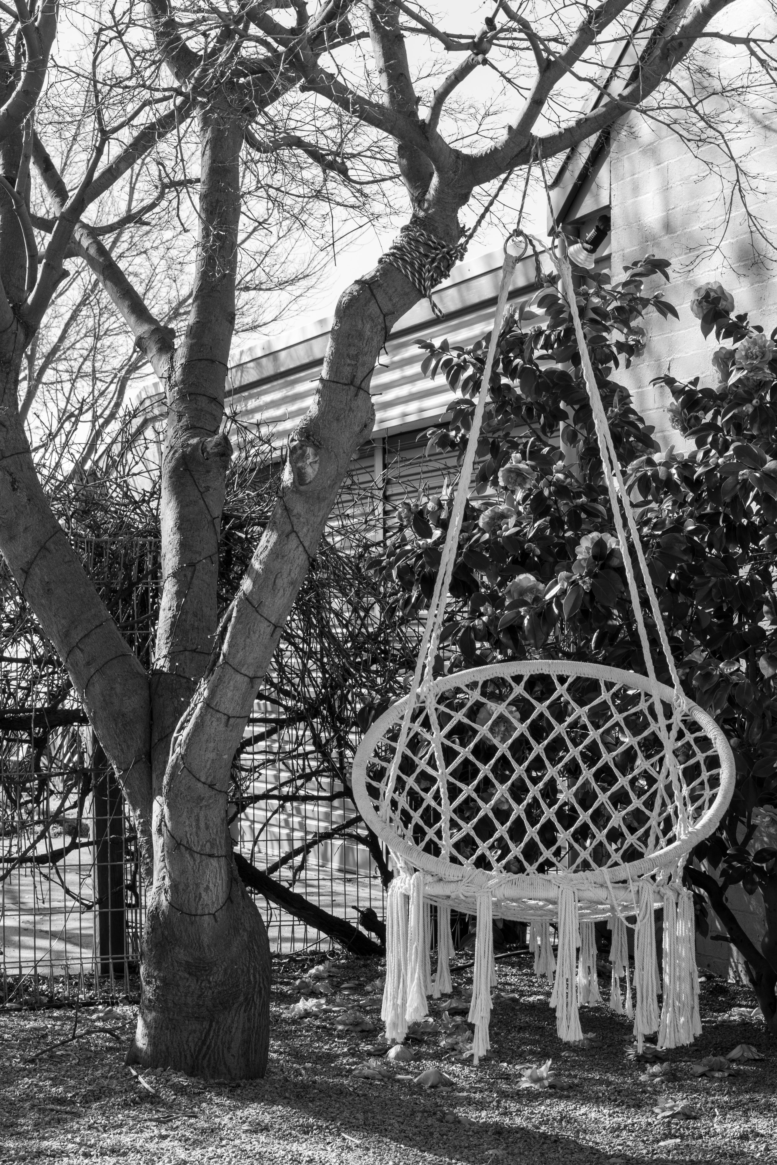 Hanging macramé chair in garden setting