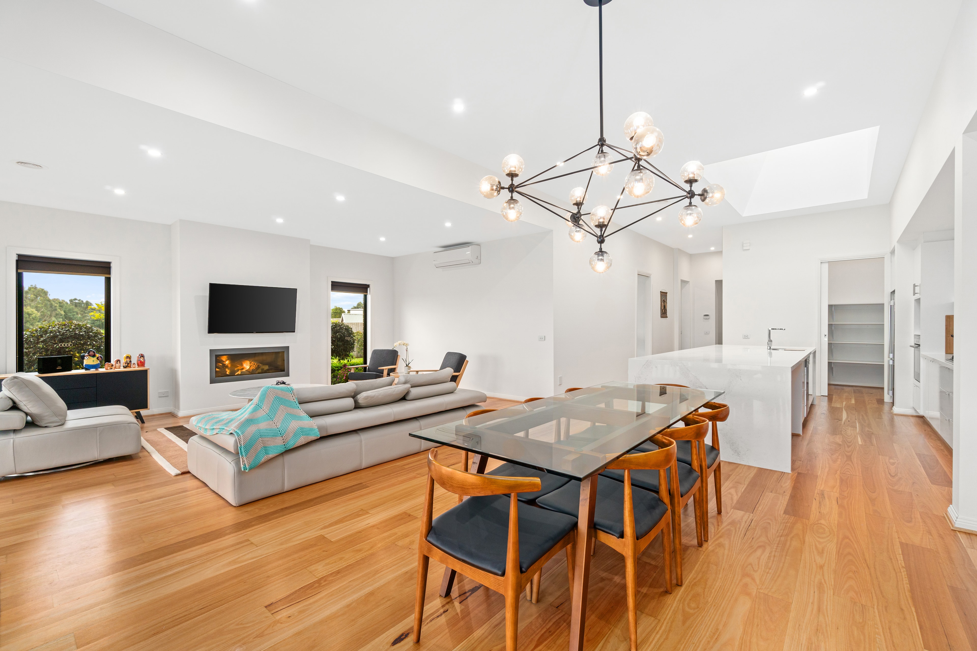 Spacious open-plan dining and living with statement chandelier