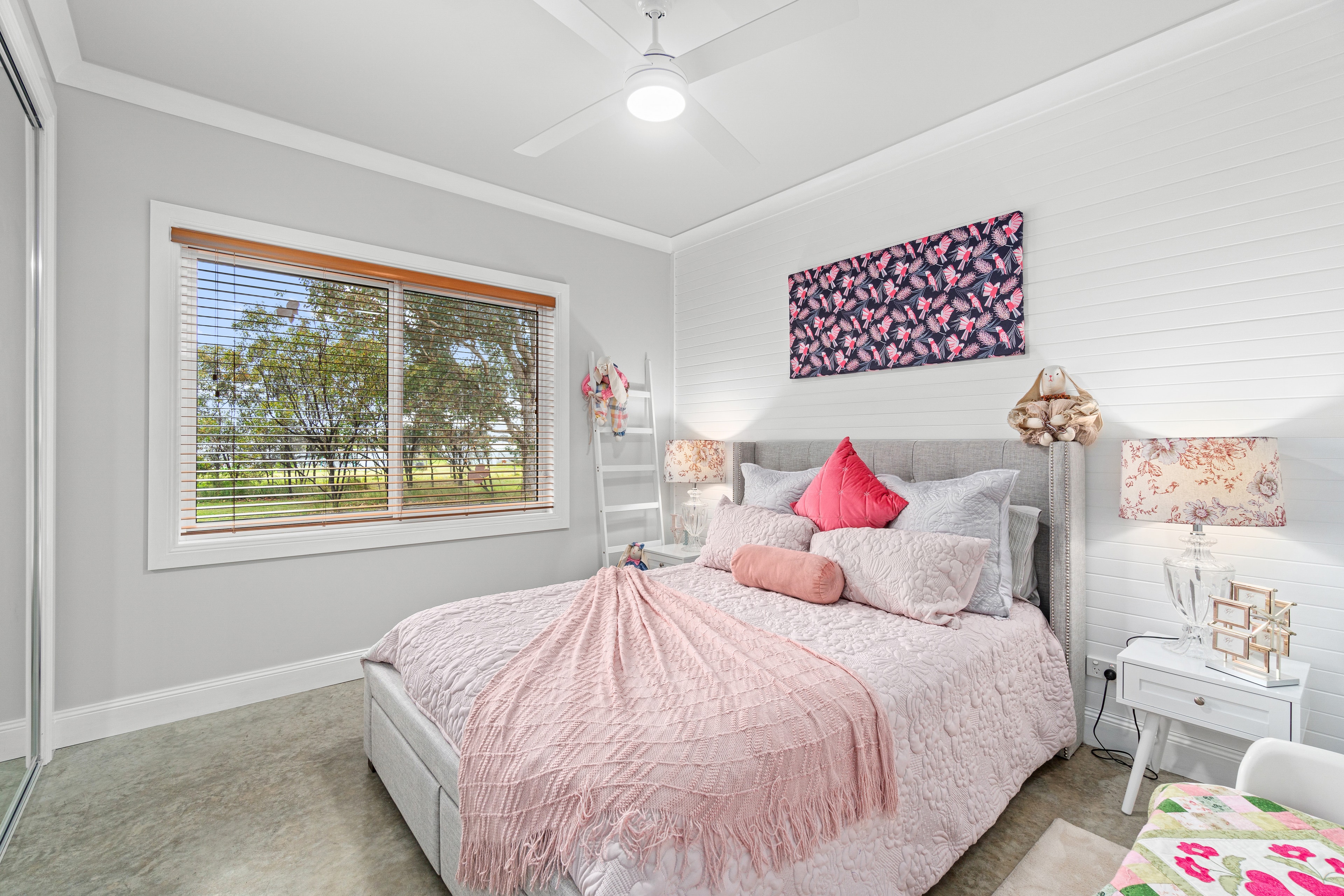 Charming bedroom with pink linen and shiplap feature wall