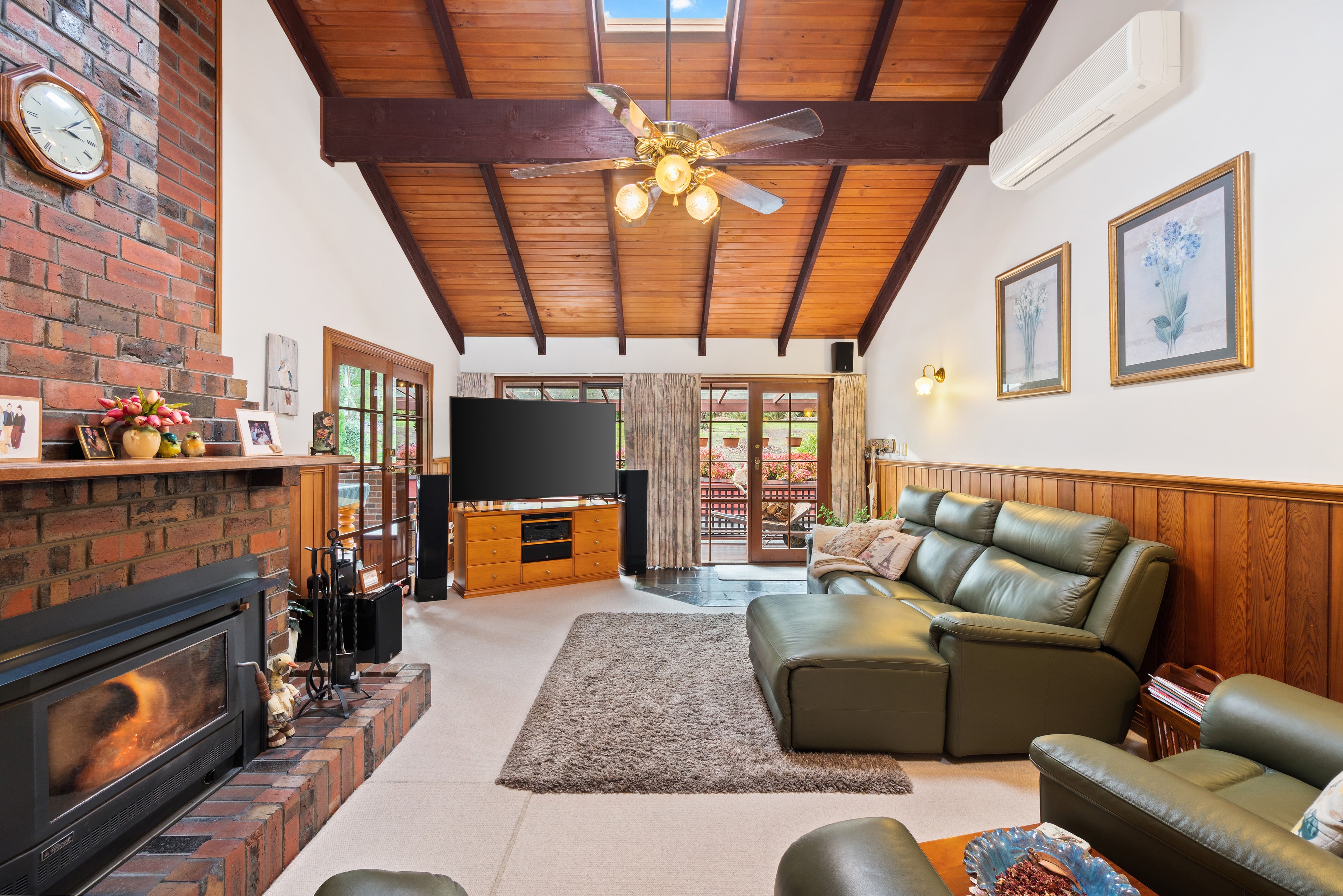 Living room with fireplace and wood ceiling